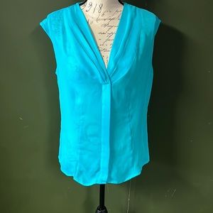 Sheer turquoise blue sleeveless button up blouse